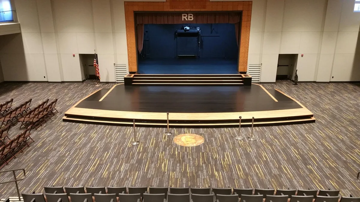 Patterned hardwood floor across a full auditorium