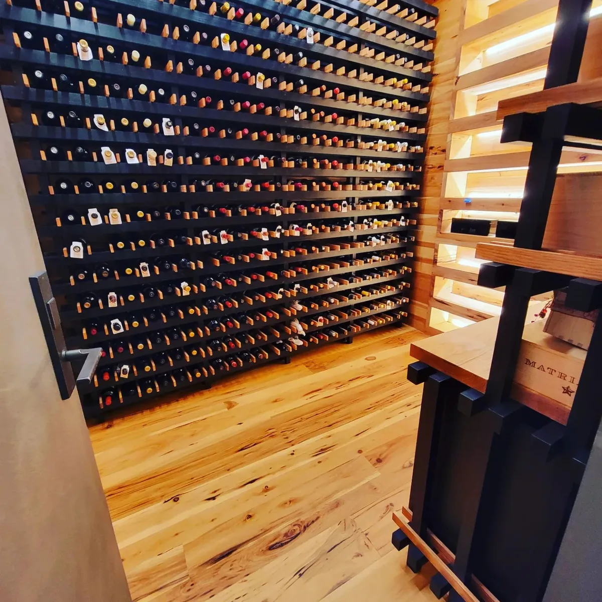 Wine cellar with custom racking and hardwood floor